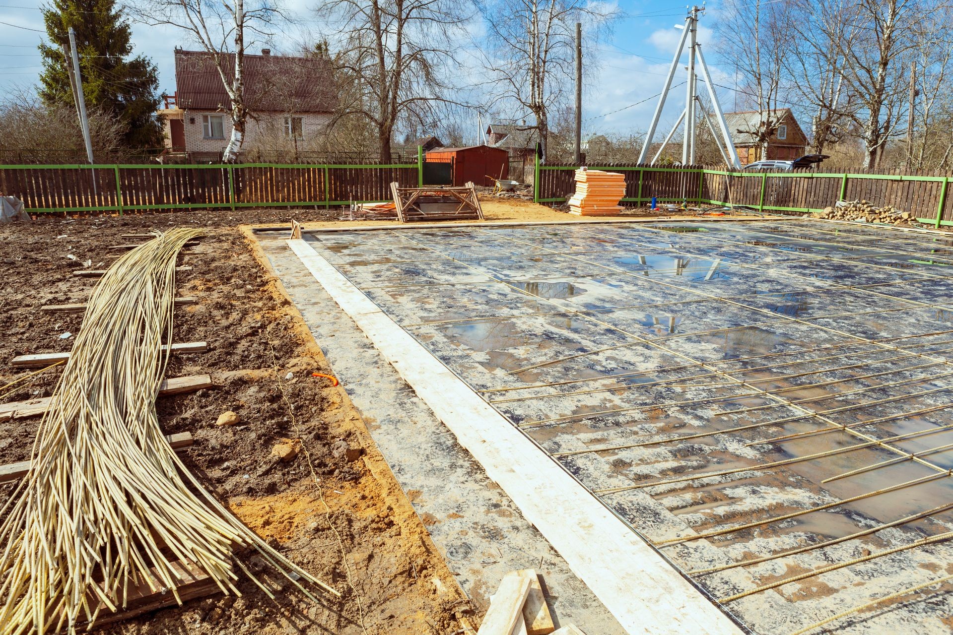 The building is under construction with new foundation after concrete pouring and making reinforcement metal framework and construction materials for that